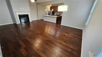 Unfurnished living room featuring baseboards, a ce