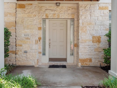 Entrance to property with stone siding