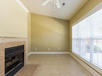 See through gas log fireplace, 10 foot vaulted ceiling, wall of windows.