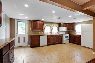 Kitchen has ceramic tile floors updated cabinets a