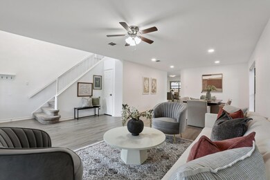 Living area with stairway, recessed lighting, woo