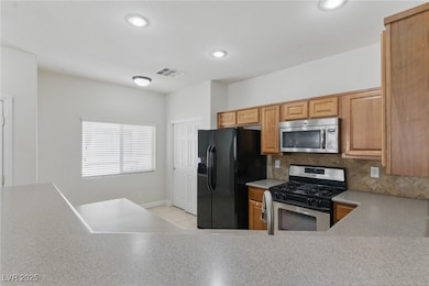 Kitchen with appliances with stainless steel finis