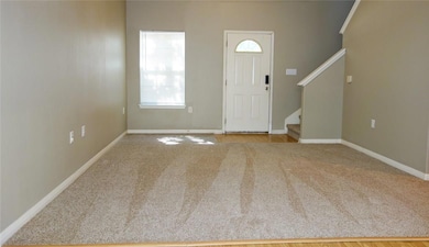 Spacious Living room has soaring high ceilings. Newer Carpet.