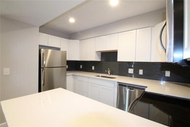 Kitchen featuring a sink, tasteful backsplash, wh