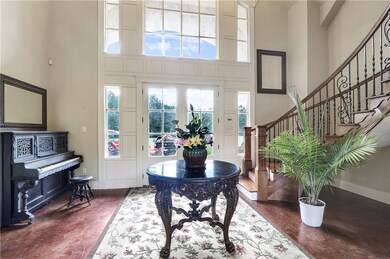 Grand double door entry with winding staircase wit