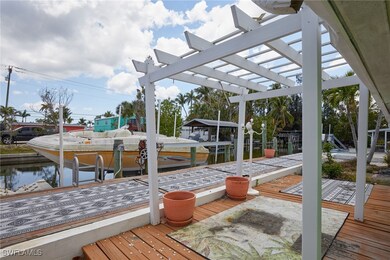 Dock area featuring boat lift and a pergola