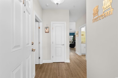 Hallway featuring light hardwood / wood-style floo