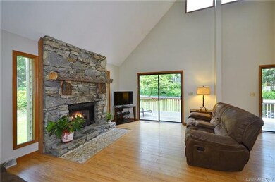 Stacked stone fireplace and rustic mantel with gas