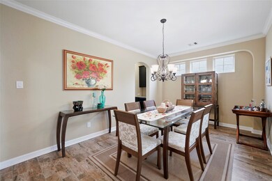The formal dining room (11x17) has plenty of natural light and a fabulous light fixture for setting the mood for a nice evening dinner.  The inset art niche in the distance has 3 custom windows and is perfect for your china cabinet or an art display.  The solid 