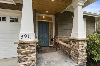 Your guests will be warm and dry in this delightful entry, graced with stacked stone and a beautiful wood finish on the entry!