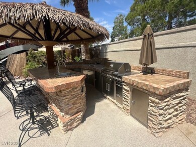 View of patio with fence, a sink, outdoor wet bar,