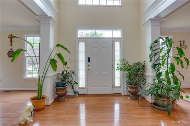 Entryway with decorative columns, wood finished fl