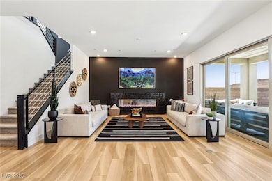 Living area featuring a glass covered fireplace, s