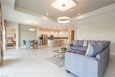 Living area with recessed lighting, a raised ceili