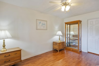 Sitting room with ceiling fan and hardwood / wood-