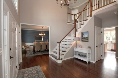 Gleaming hardwood floors, grand staircase, white t