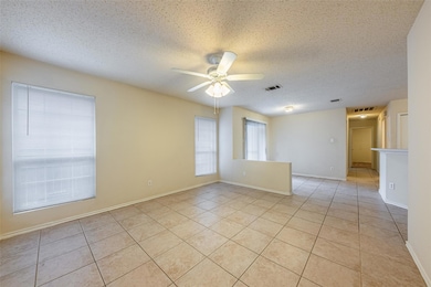 Unfurnished room featuring light tile patterned f