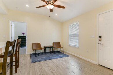 Living area featuring a ceiling fan, vaulted ceil