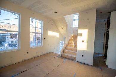 Unfurnished living room with stairs