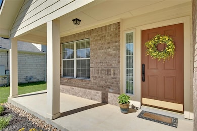 View of exterior entry with brick siding and cove