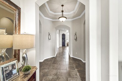 Step inside and fall in LOVE! Upon entering you are greeted with a gorgeous foyer with crown molding, an 11 foot ceiling, neutral decorator paint, & shining tile floors! The rotunda has an elegant bronze chandelier, tray ceilings that reach 12 feet, and crown molding. To the right, you will find a deep coat closet, the half bath, mudroom and access to the 3-car garage. A bedroom and bathroom suite is to the left.