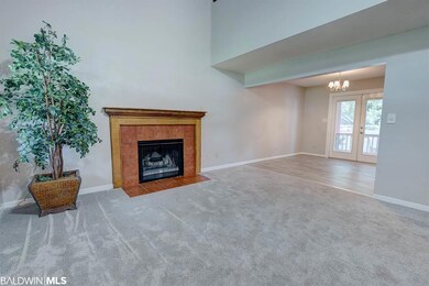 Features woodburning fireplace & cathedral ceiling