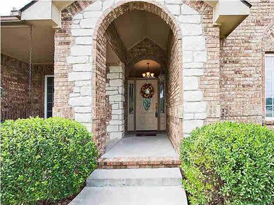 The stone and brick arched entry welcomes you onto