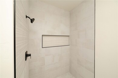 Full bathroom featuring a tile shower