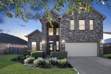 Charming two-story brick home with lush landscaping