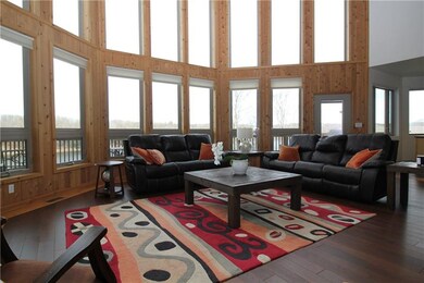 Living room with wall of windows overlooking the l