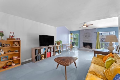 Living area with concrete floors, a ceiling fan, 