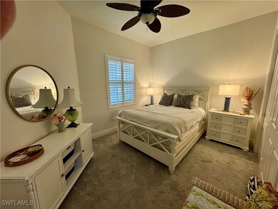 Bedroom featuring dark colored carpet, a ceiling f