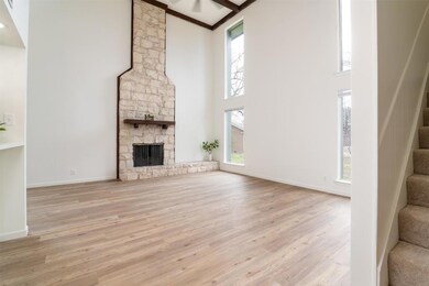 Unfurnished living room featuring high vaulted ce