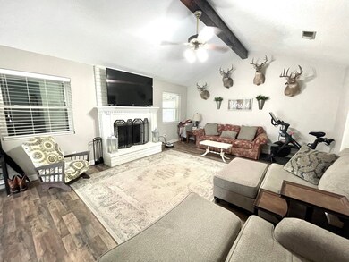 Large Family room with beamed cathedral ceiling and gas wood burning fireplace to keep you warm when it's freezing outside