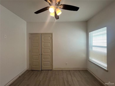 Spare room featuring wood tiled floors and a ceiling fan