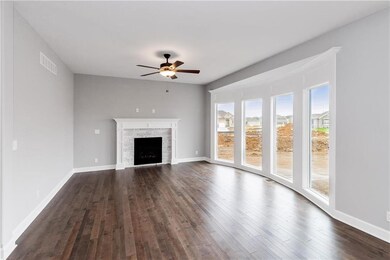 Main living area with abundant windows. Gas firepl