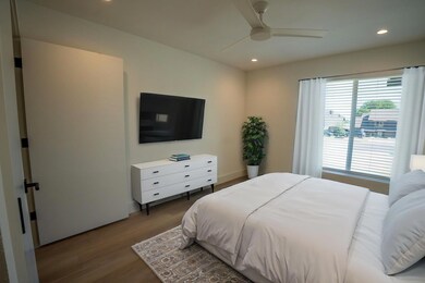 Bedroom with wood finished floors, recessed light