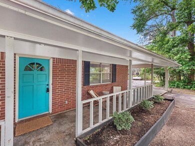 This is a cozy single-story home featuring a red b