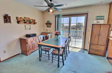 Dining area off kitchen with ceiling fan and slide