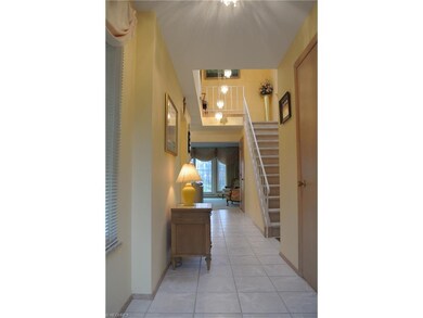 Front door opens to wide hall with ceramic tile an