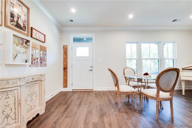 Dining space with dark hardwood / wood-style floor