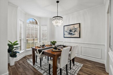 Dining room with an inviting chandelier, dark wood