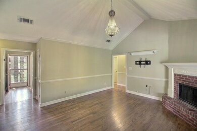 Unfurnished living room featuring ornamental moldi