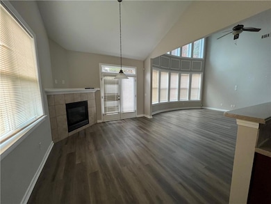 Unfurnished living room featuring dark hardwood / 