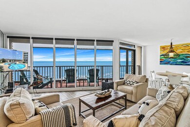 Living room with a wall of windows and great ocean