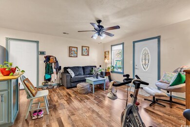 Living room featuring wood-type flooring, a textur