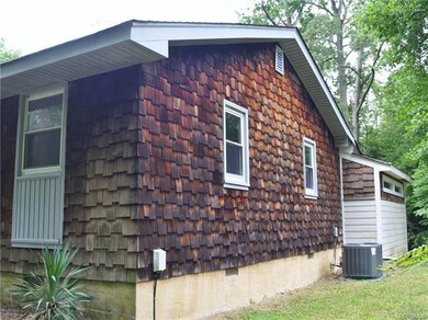 Right end of dwelling- Cedar Shake siding.