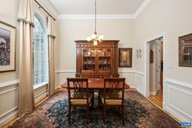 The dining room features crown molding, chair rail