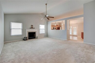 Great room with vaulted ceiling, fireplace and ceiling fan