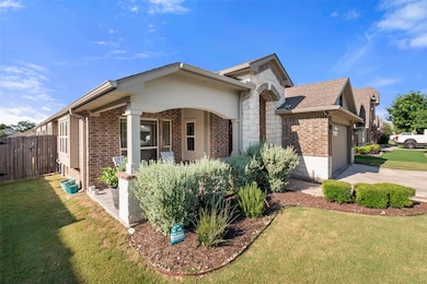 View of front of home with brick siding, an attac
